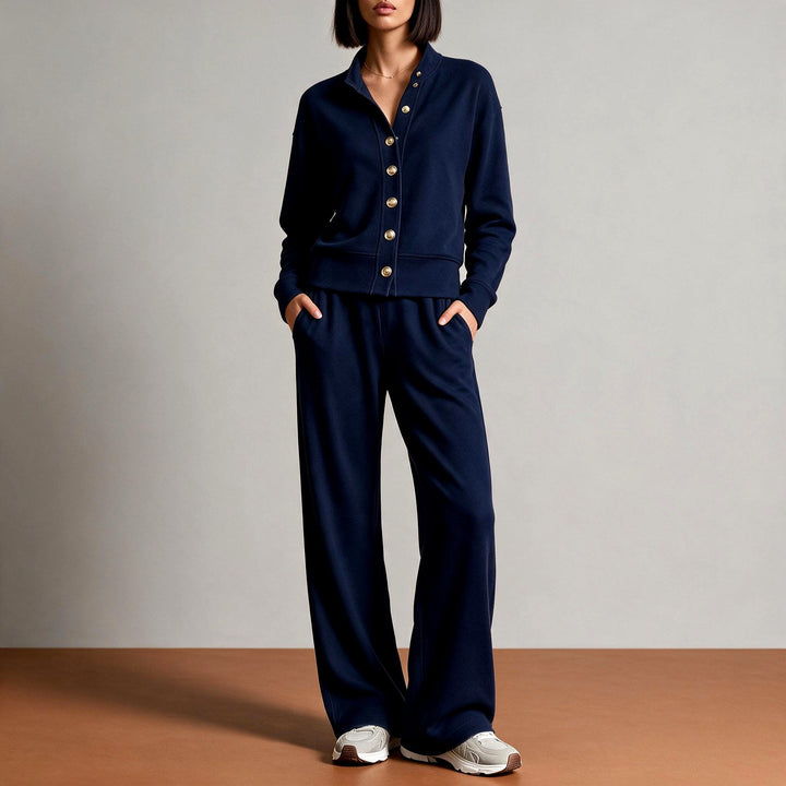 Front view showing button placket, banded waist and wide leg trousers, dark blue