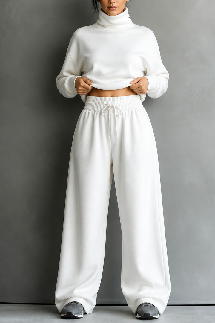 Front view of turtleneck top with banded waist and wide-leg trousers, white