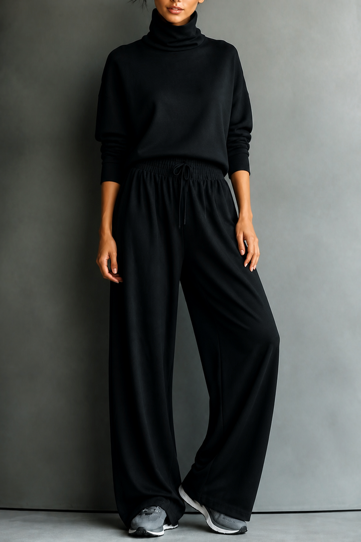 Front view of turtleneck top with banded cuffs, banded waist and wide-leg trousers, black