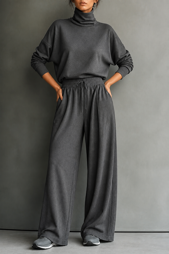 Front view of turtleneck top with side pockets, banded waist and wide-leg trousers, grey