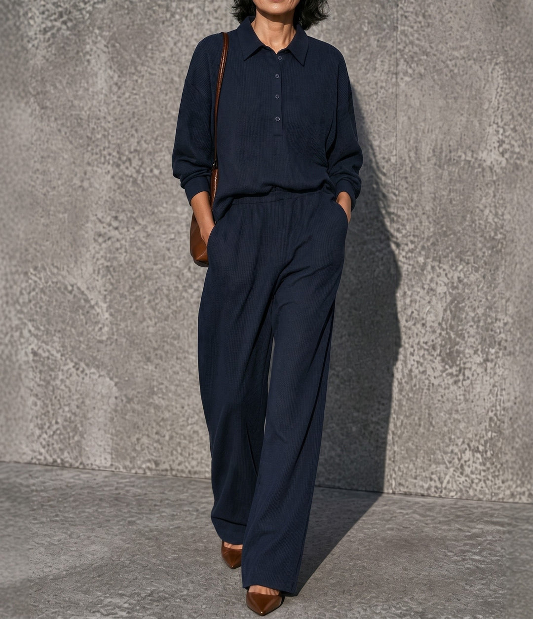 Front view showing collar, button placket and wide legs, navy