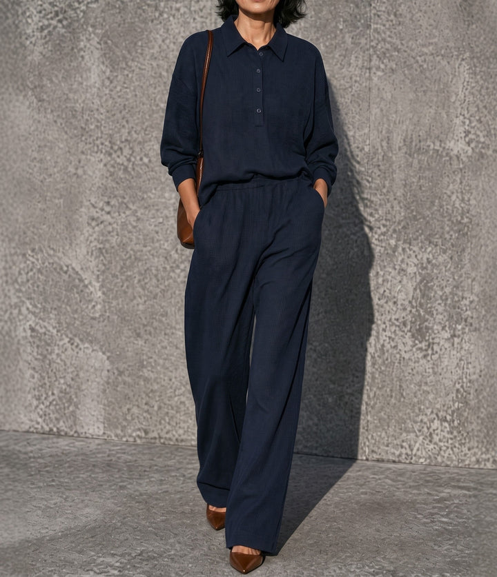 Front view showing collar, button placket and wide legs, navy
