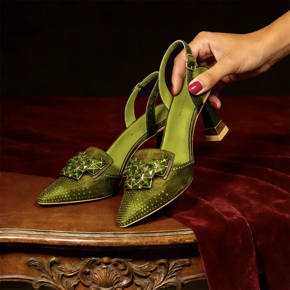 Side view of studded pointed toe upper with jeweled buckle plate and slingback strap