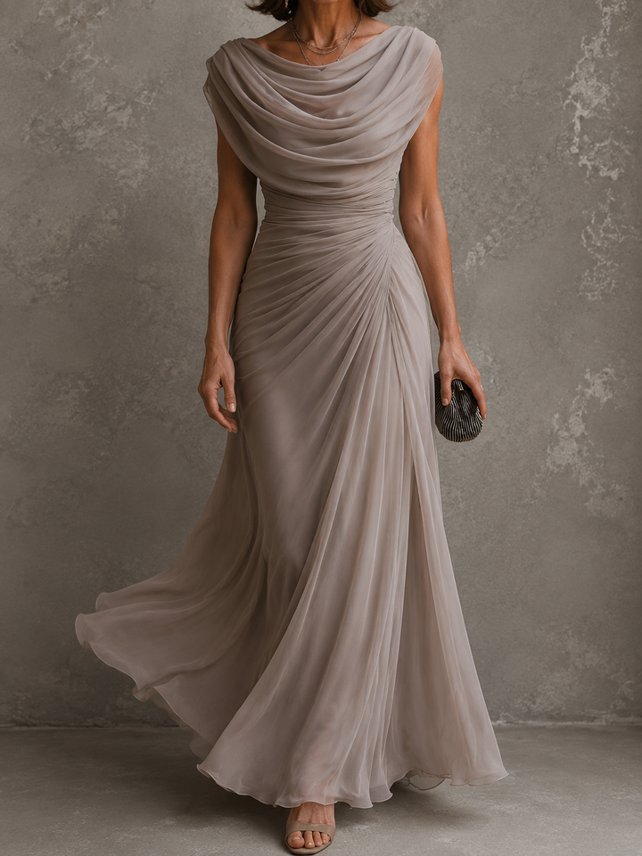 Front view of cowl neckline, ruched waist and draped skirt