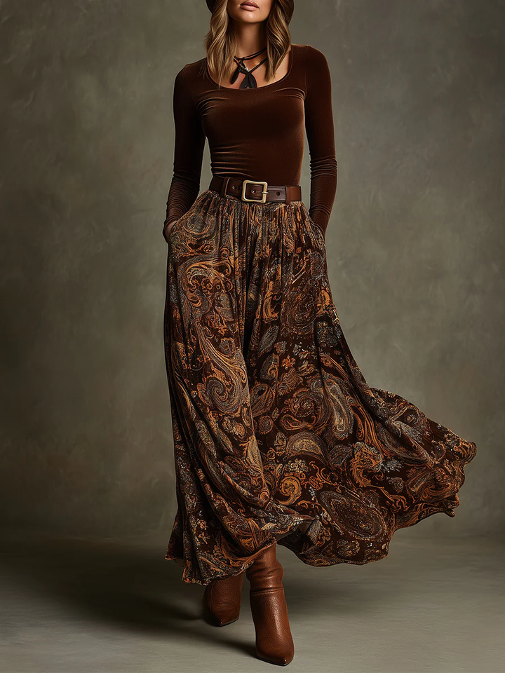 Front view of top with round neckline, long sleeves, belted waist and floor-length skirt, brown