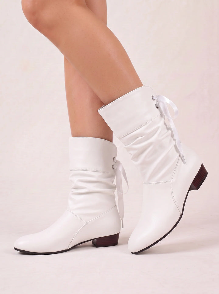 Side view showing ruched shaft, back lacing and block heel, white