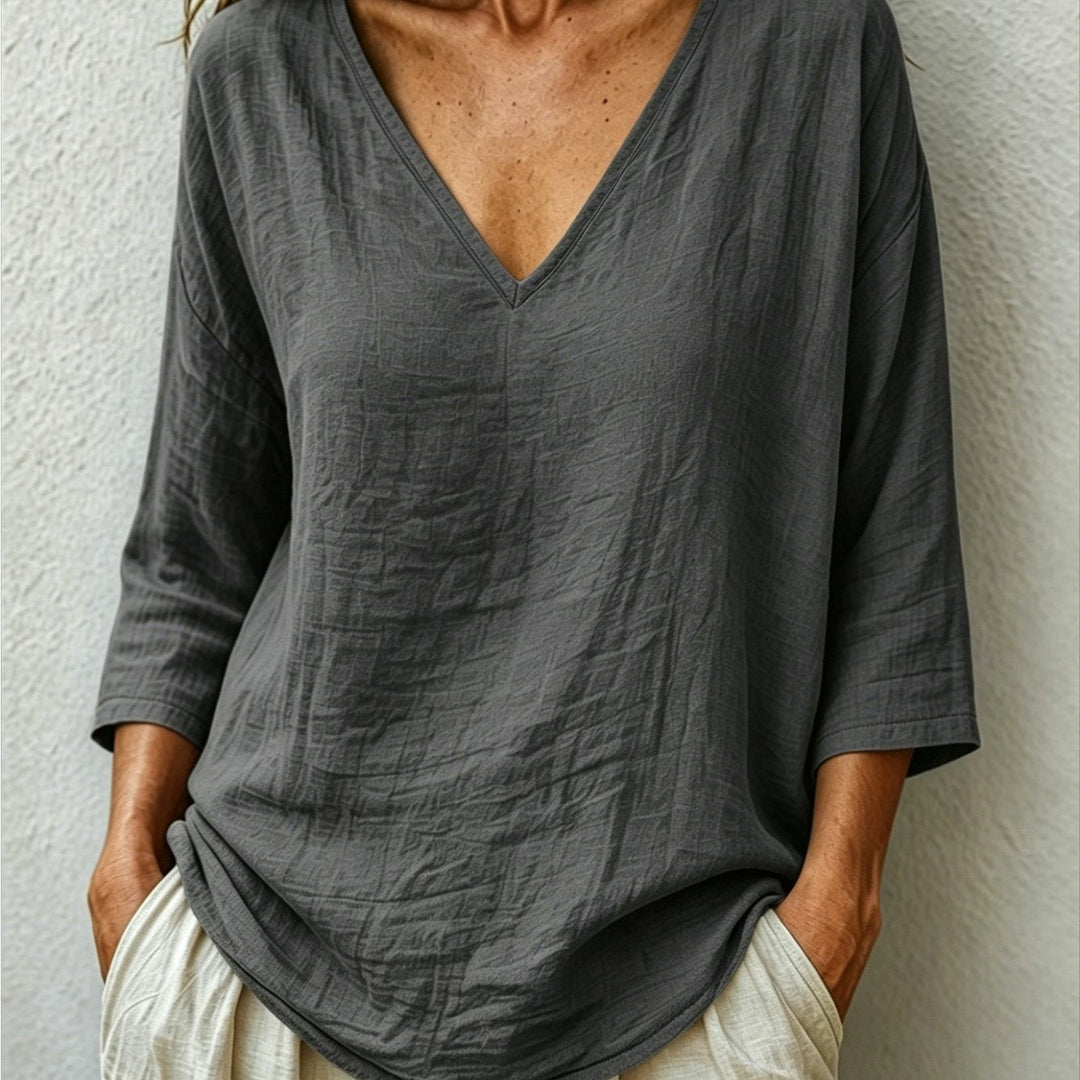 Front view showing v-neckline and three-quarter sleeves, dark grey