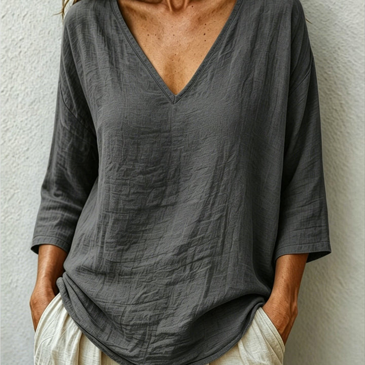 Front view showing v-neckline and three-quarter sleeves, dark grey