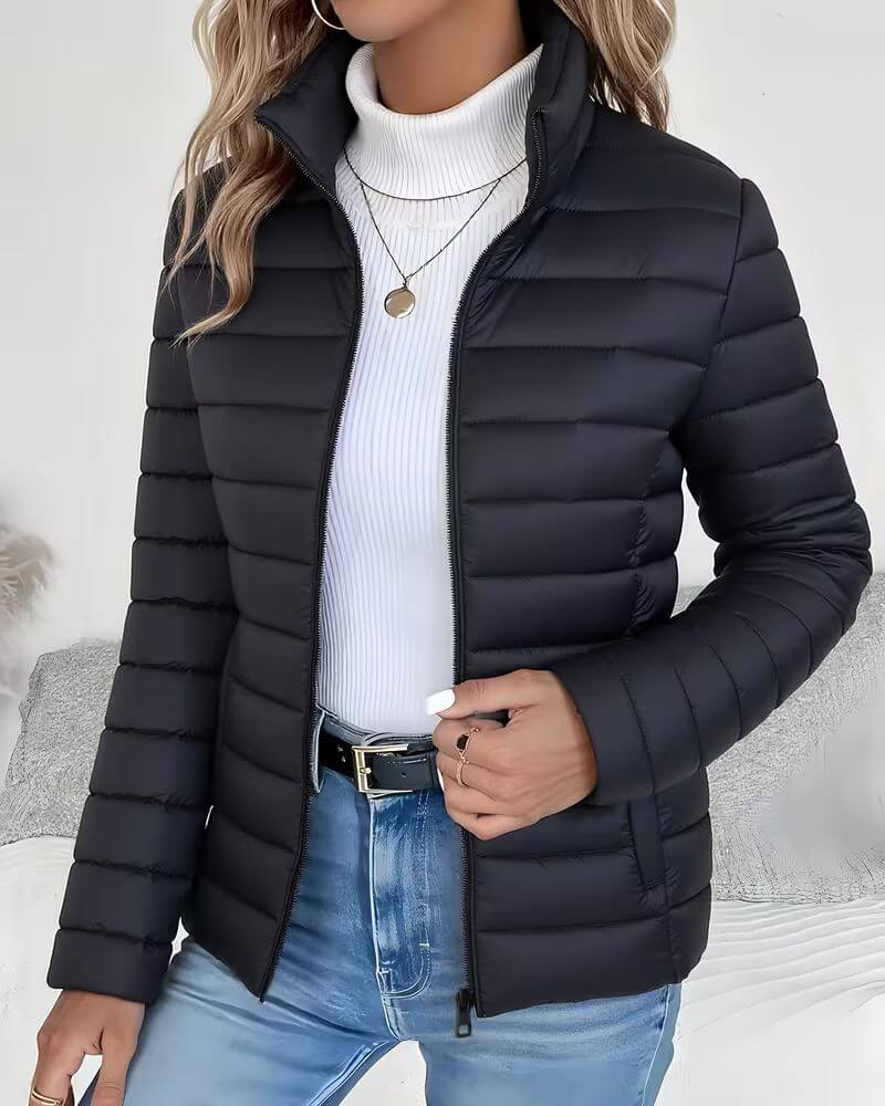 Front view showing stand collar, zip closure and quilting, black