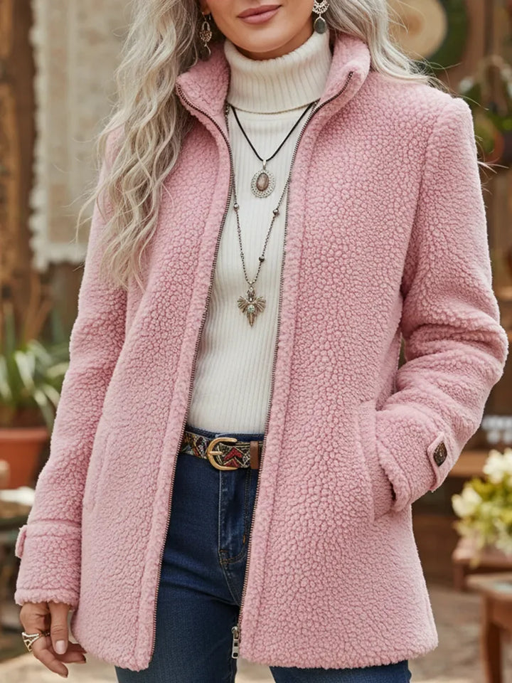 Front view showing stand collar, full-length zip and side pockets, pink