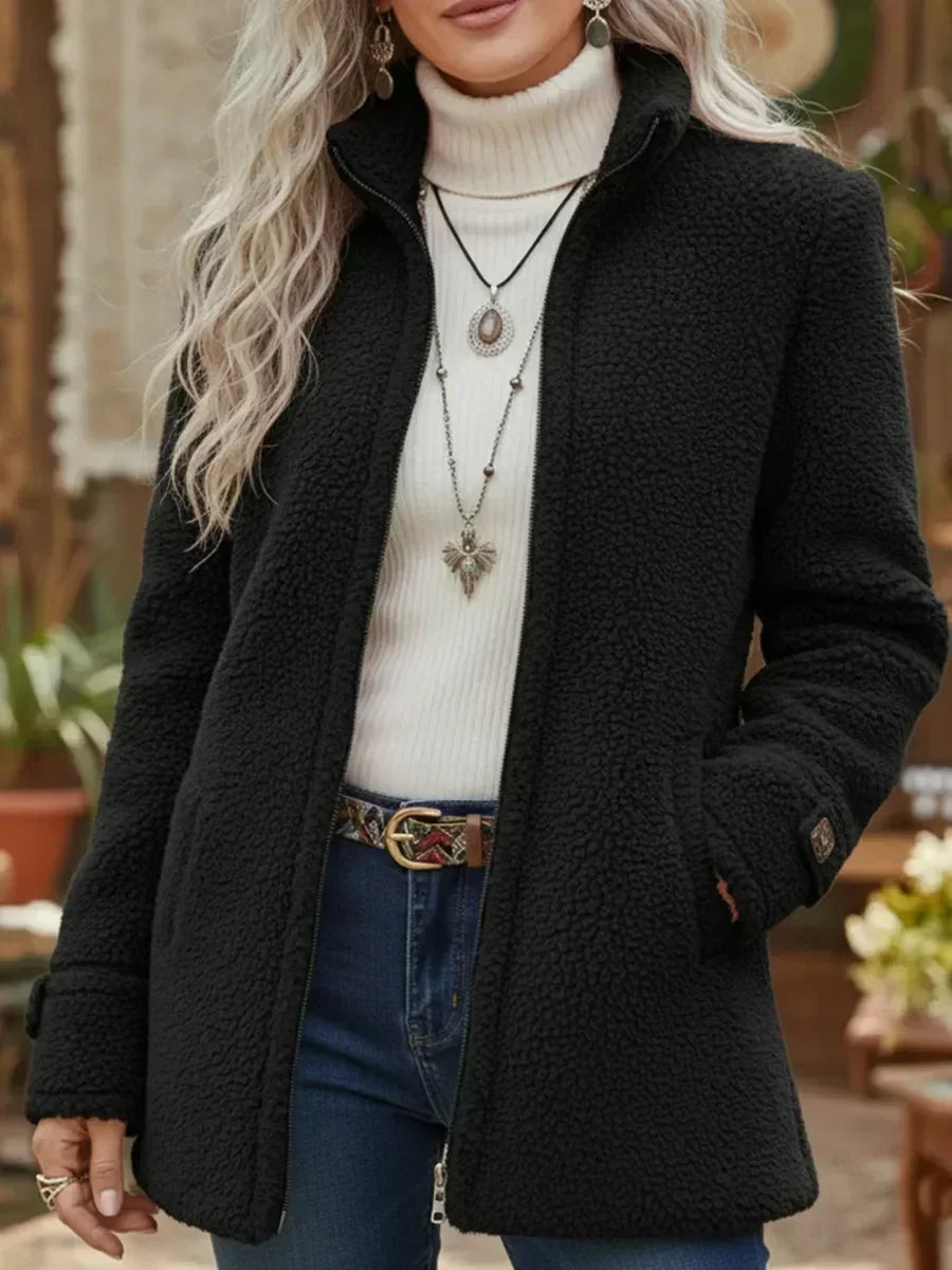 Front view showing stand collar, full-length zip and side pockets, black