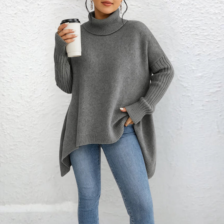 Front view showing turtleneck, dropped shoulder seams and banded cuffs, grey