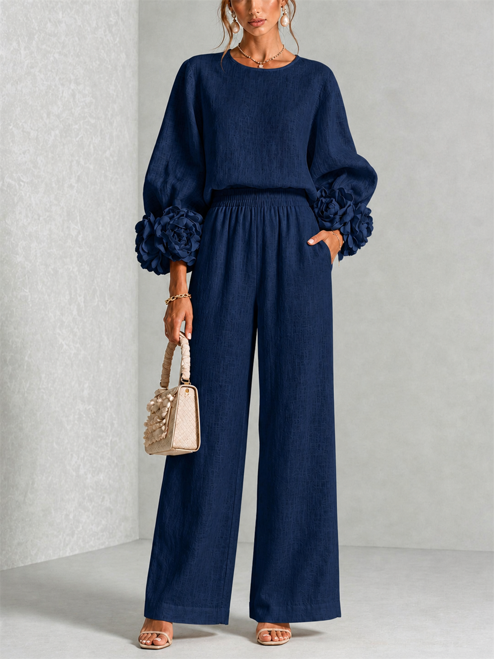 Front view of round neckline, floral cuffs, side pocket and wide legs, dark navy