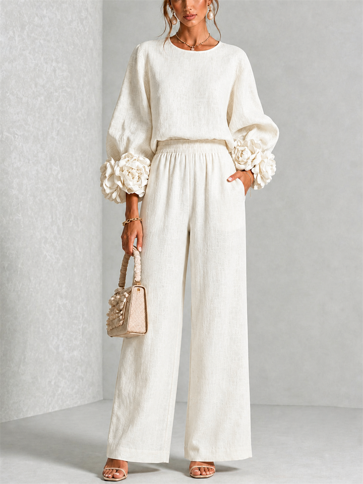 Front view of round neckline, floral cuffs, banded waist and wide legs, ivory
