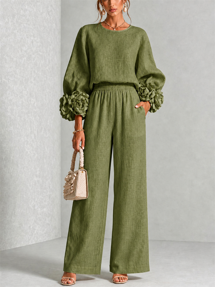 Front view of round neckline, floral cuffs, side pocket and wide legs, olive green