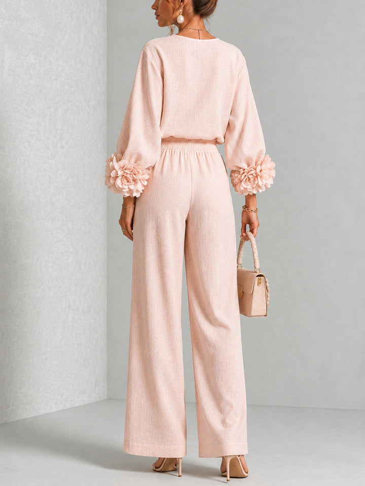 Back view of top, floral cuffs, banded waist and wide legs