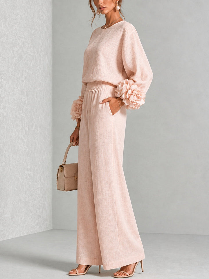 Side view of long sleeves, floral cuffs, banded waist and wide legs
