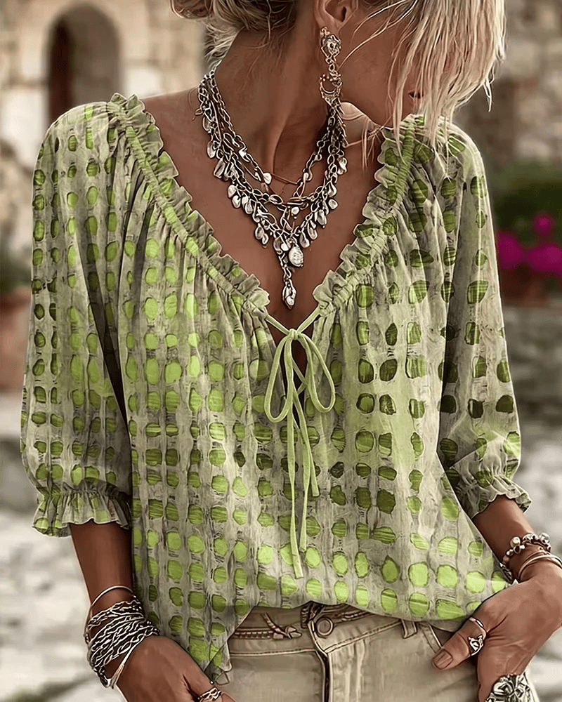 Front view of v-neckline with tie fastening, ruffle trim and puff sleeves, green
