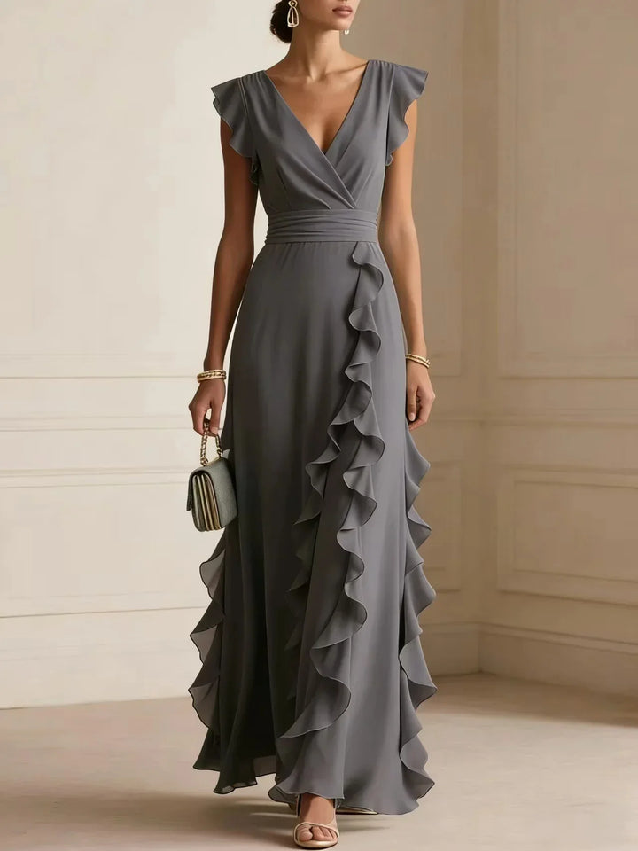 Front view showing wrap bodice, banded waist and ruffle trim, charcoal grey