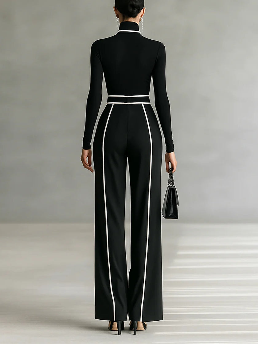 Back view showing turtleneck, long sleeves, banded waist and wide legs