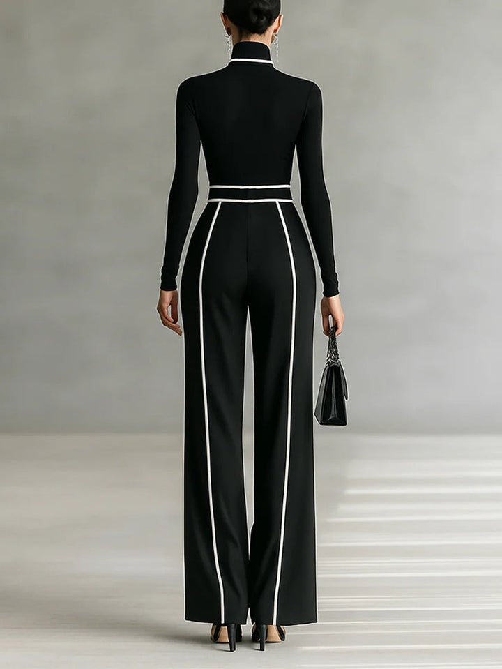 Back view showing turtleneck, long sleeves, banded waist and wide legs