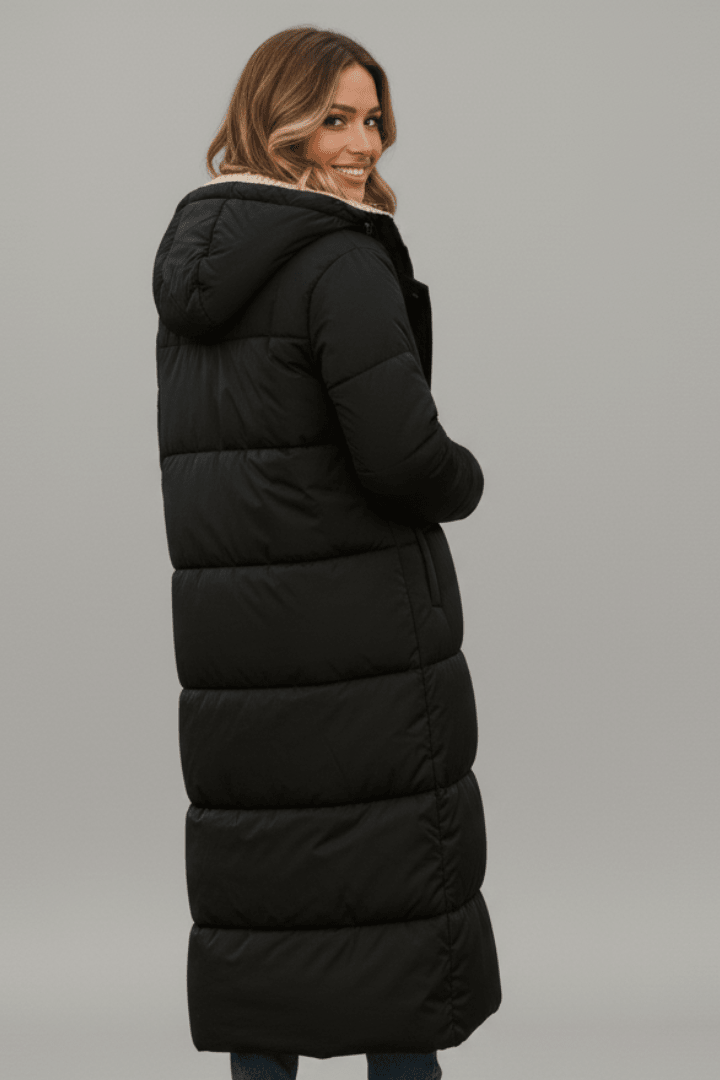 Back view showing hood, quilted panels and ankle-length hem