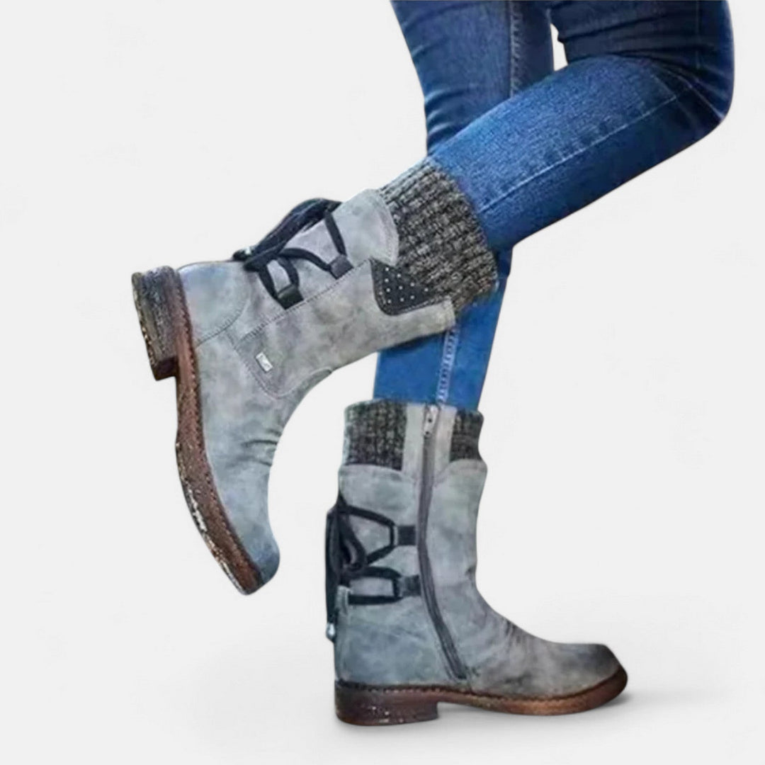 Front view showing side zip, studded panel and ribbed cuff, grey