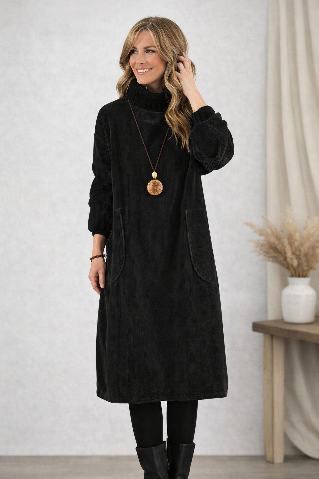Front view showing turtleneck, long sleeves and patch pockets, black
