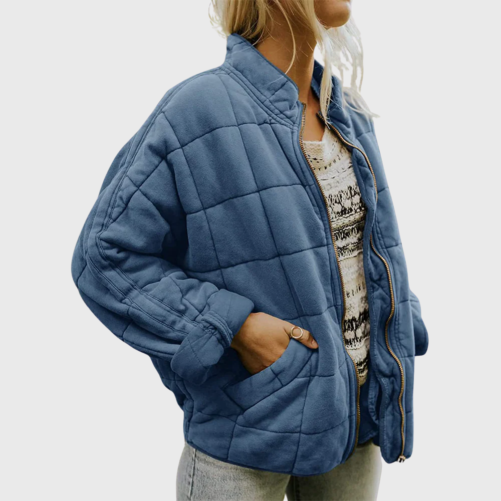 Front view showing stand collar, zip front and side pocket, blue
