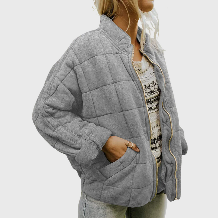Side view showing stand collar, dropped shoulder seam and side pocket, grey