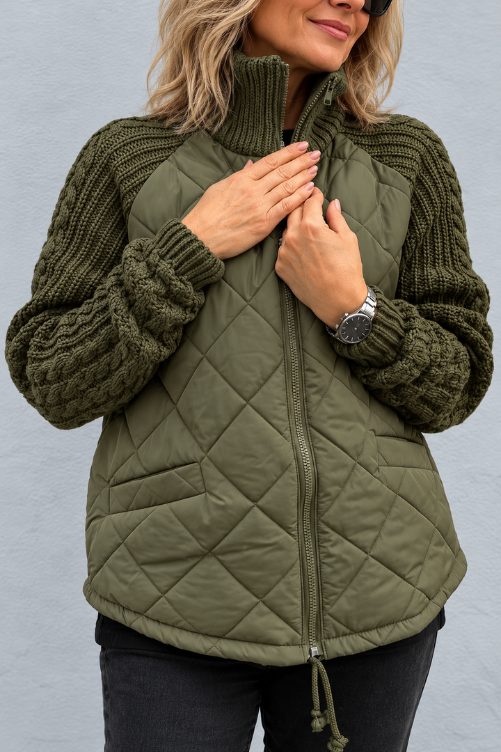 Front view showing stand collar, banded cuffs, quilted body, side pocket and front zip, green