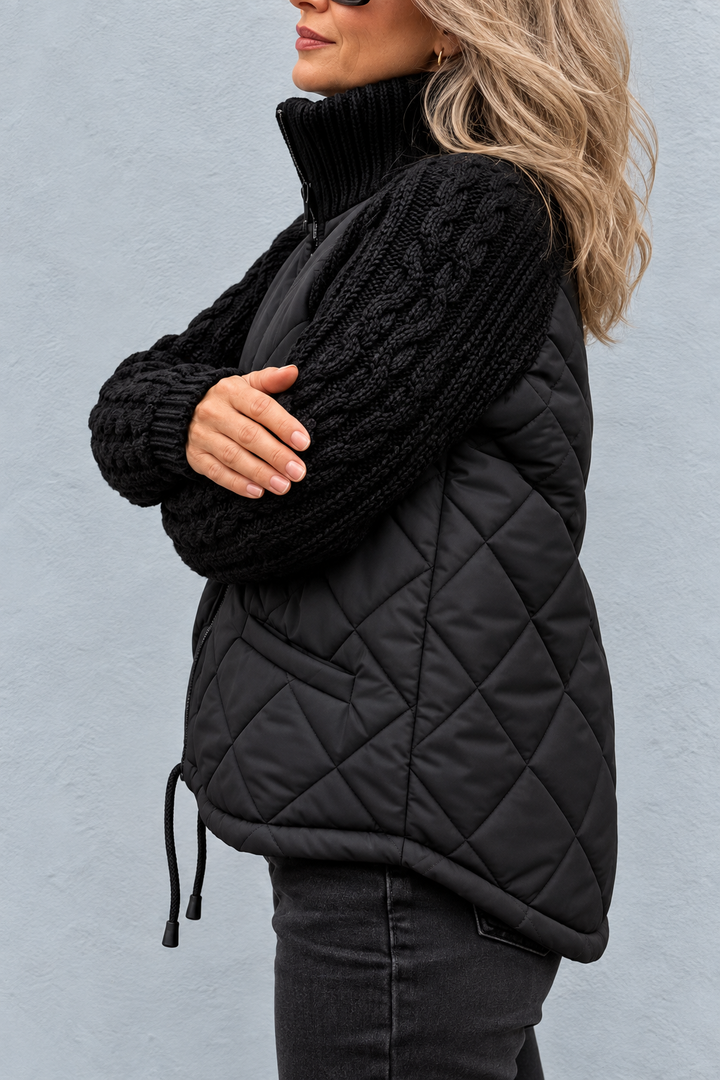 Side view showing cable sleeve, quilted body side seam and drawstring hem with toggle